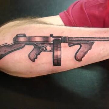 What do the various gun tattoos represent?